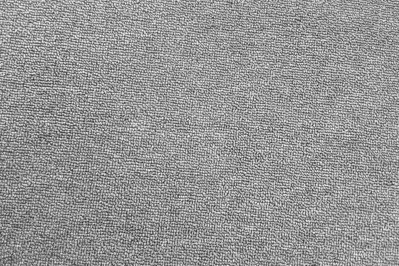 The texture of the grey carpet. The background of grey cloth. Top view